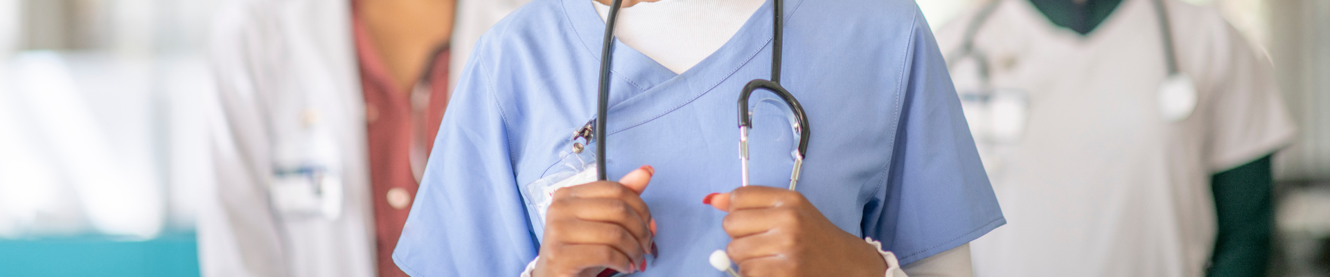 Medical professionals in scrubs and lab coats with stethoscopes, representing ProjectLink's project management solutions for the healthcare industry