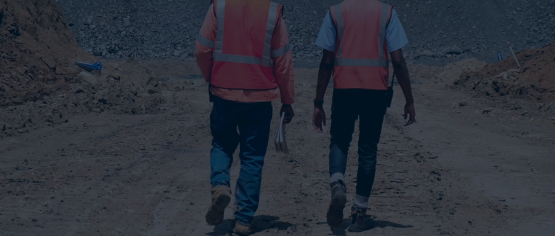 Project risk management in Africa – mining professionals walking through an open-pit mining site